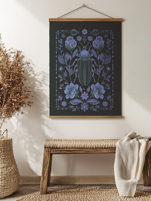 A symmetrical dark wall tapestry featuring a large iridescent blue beetle centered among intricate floral motifs and botanical elements on a black background, suspended from a wooden dowel with twine.